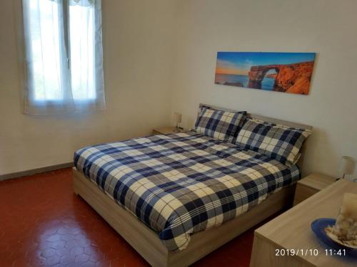 a small bedroom with a bed and a window at Ca' Federica in Vallecrosia
