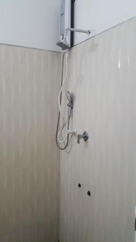 a shower in the corner of a bathroom at Rivonway Hotel Polonnaruwa in Polonnaruwa