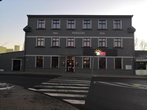 a large black building with a sign on it at Sun-House Pension&Restaurant -ParkingFree- in Prague