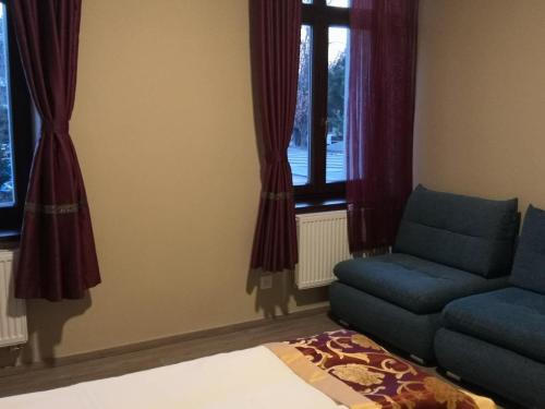 a living room with a couch and a window at Sun-House Pension&Restaurant -ParkingFree- in Prague