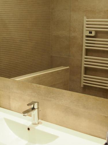 une salle de bain avec un lavabo et un miroir dans l'établissement Les Terrasses de la Mer, à Menton