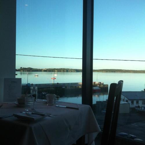 a table in a restaurant with a view of the water at The Waterfront Hotel in Baltimore
