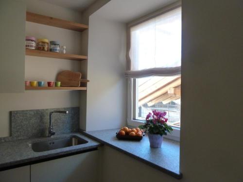 a kitchen counter with a sink and a window at Casa Lassù in Carano