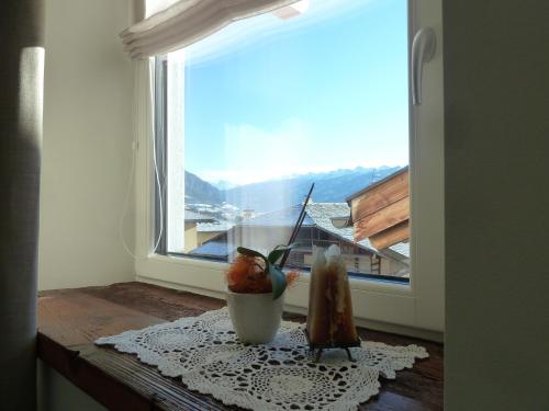 a window with a vase on a table in front of it at Casa Lassù in Carano