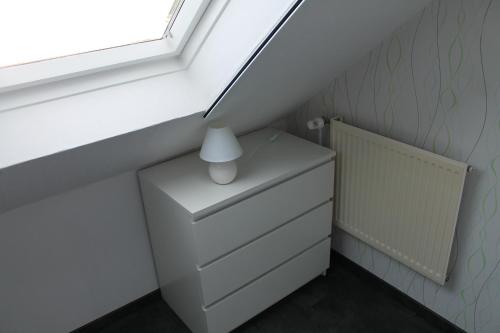 a room with a white dresser and a window at Fewo Seifert in Schortens