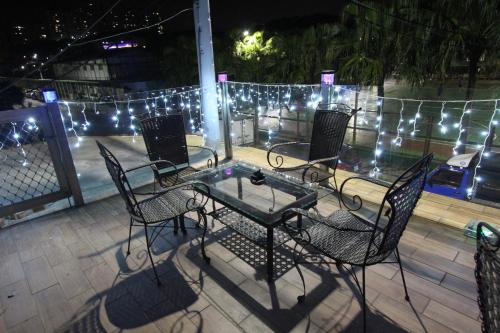 a table and chairs on a patio with lights at Sea Keelung in Keelung