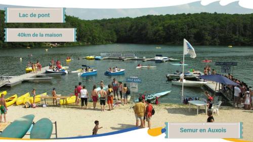 a group of people on a beach with boats in the water at Gite de Chassigny in Avallon