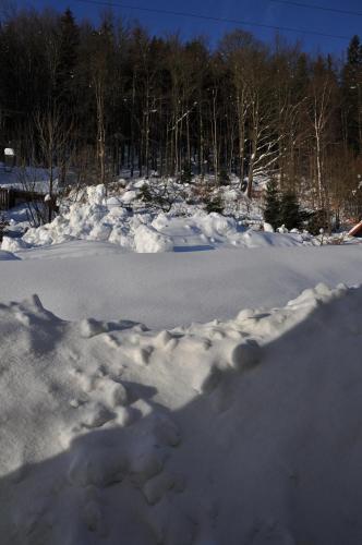 a pile of snow on the side of a road at Apartmány pod Mariánskými schody in Albrechtice v Jizerských horách