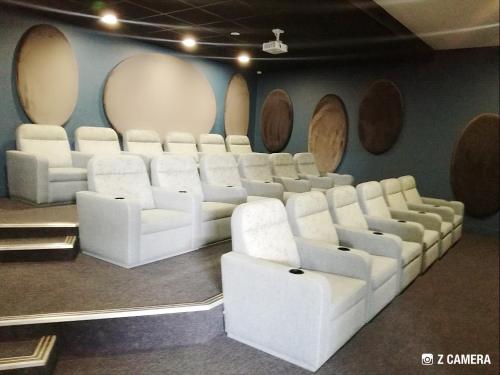 a conference room with white chairs and a wall with round mirrors at The Blyde - Crystal Lagoon Penthouse Apartment in Pretoria