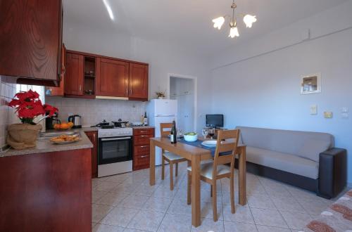 a kitchen with a table and a kitchen with a couch at Nafplio view in Nafplio