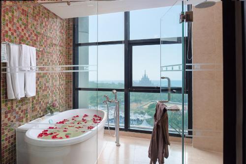 a bathroom with a bath tub with flowers on it at The Zign Hotel in Pattaya North