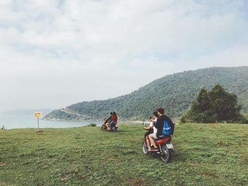 a group of people riding motorcycles on a hill at Sunbay Homestay Cu Lao Cham in Tân Hiệp