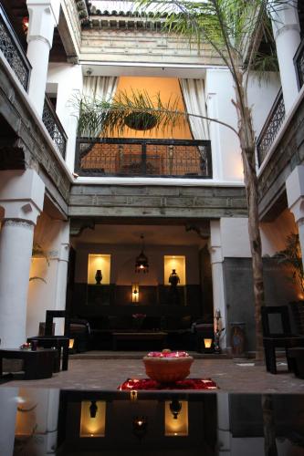 a lobby of a building with a bowl in the middle at Riad Terra Bahia in Marrakech