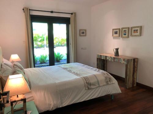 a bedroom with a bed and a window at Villa Astreia in Bel Ombre