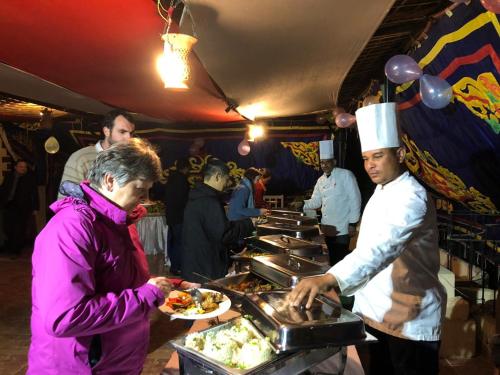 a man in a chefs hat preparing food at a buffet at El Mesala Hotel in Luxor