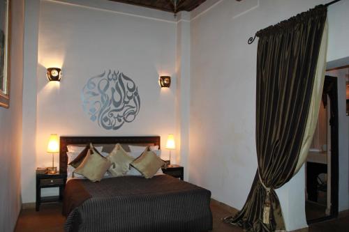 a bedroom with a bed in a room at Riad Terra Bahia in Marrakech