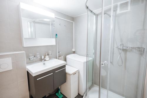 a bathroom with a shower and a sink and a toilet at ☆ Central Apartment with Montreux View ☆ in Montreux