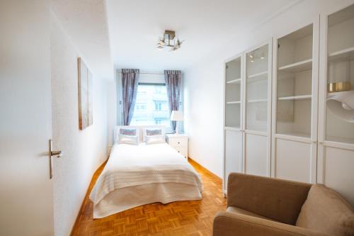 a bedroom with a bed and a couch and a window at ☆ Central Apartment with Montreux View ☆ in Montreux