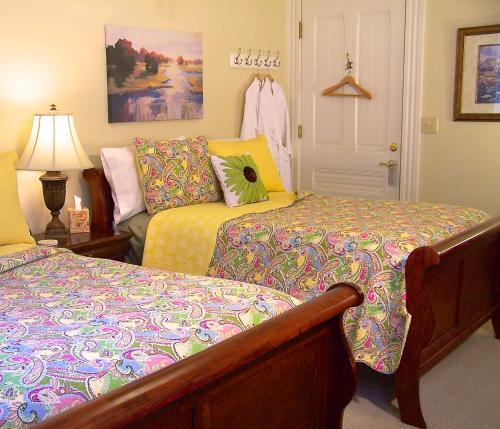 a bedroom with two beds and a lamp at Lyndon House Bed & Breakfast in Lexington
