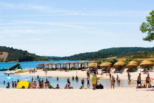 a group of people on a beach with umbrellas at Casa do Ti Correia in Macedo de Cavaleiros