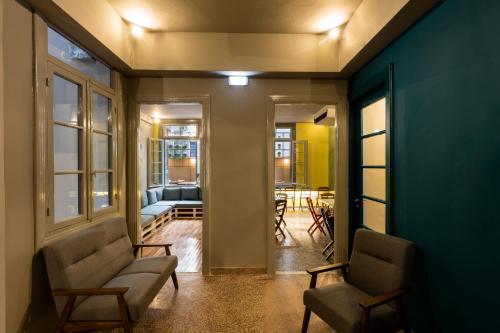 a hallway with two chairs and a living room at Nubian Hostel in Athens