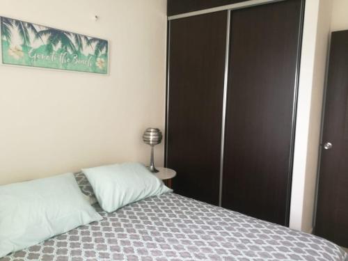 a bedroom with a bed and a black closet at Playa La Barqueta , Las Olas Tower Front in David