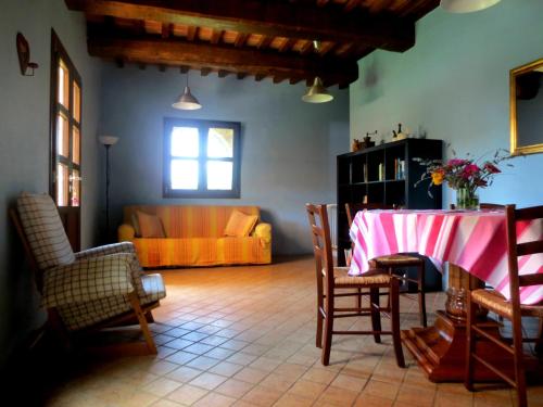 a living room with a table and a couch at Apartment with privat garden in Montegabbione