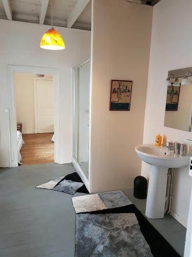 a bathroom with a sink and a mirror and a sink at Chambres d'hôtes Chez Valérie Garage motos et vélos in Arette