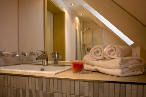a bathroom with a sink and a towel at Hotel Donau in Donauwörth