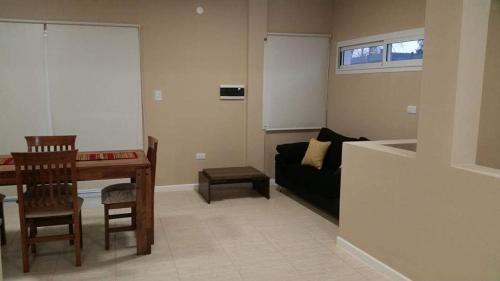 a living room with a table and a couch at ALQUILER TEMPORARIO VILLA UNION in Villa Unión