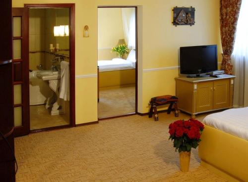 a hotel room with a television and a bathroom at Отель Фараон in Kyiv