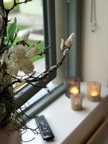 a window sill with candles and flowers and candles at Beechwood 4, Kenmare Luxurious Living in Killowen