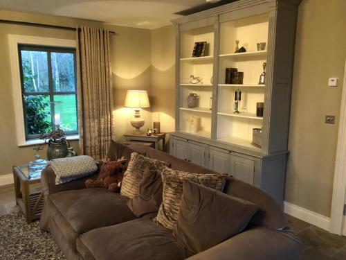a living room with a couch and a window at Beechwood 4, Kenmare Luxurious Living in Killowen
