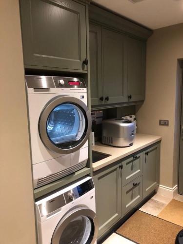 a kitchen with a washing machine and a washer at Beechwood 4, Kenmare Luxurious Living in Killowen
