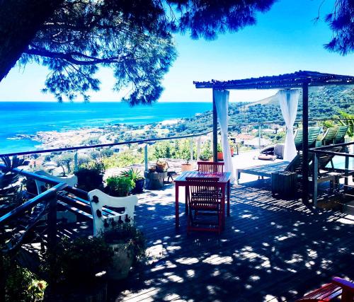 a patio with a table and chairs and the ocean at Boutique@10 in Cape Town
