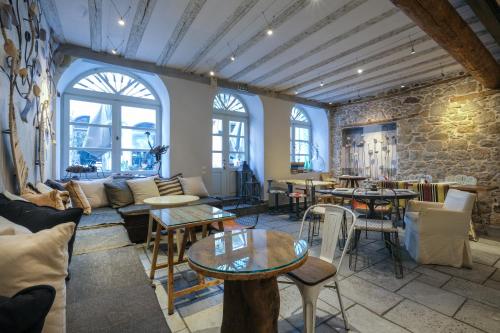 a room with a couch and tables and windows at Amymone and Adiandi in Nafplio