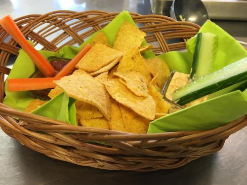 a basket filled with chips and vegetables on a table at Brunsbo G:a Biskopsgård Hotell & Konferens in Skara