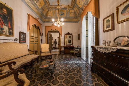 a living room with a couch and a table at Palazzo Framarino dei Malatesta - Noble Floor - XIV Century in Giovinazzo