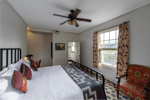 a bedroom with a bed and a ceiling fan at Hotel Congress in Tucson