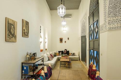 a living room with a couch and a table at Riad Yamcha in Meknès