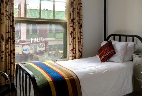 a bedroom with a bed and a window with a view at Hotel Congress in Tucson