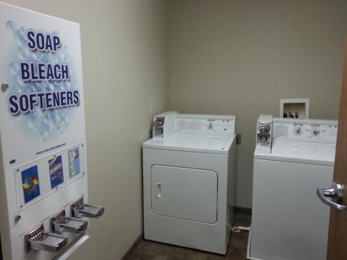 a laundry room with a washing machine and a washer at Travelodge by Wyndham McAlester in McAlester