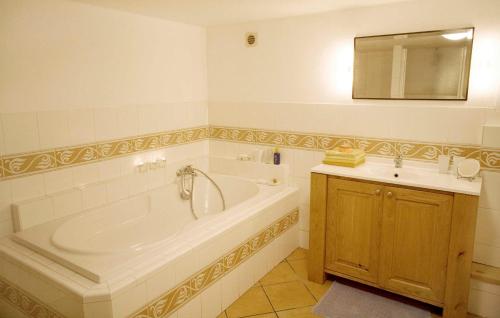 a bathroom with a large tub and a sink at Maison Marie Elise in Marquixanes