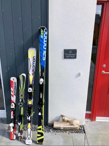 a group of skis leaned up against a wall at Ventoux in Aviemore