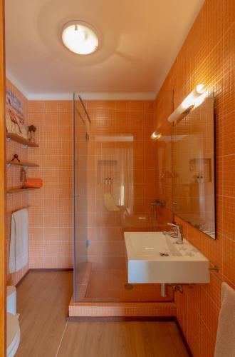 a bathroom with a sink and a shower at River-side Villa in Vila Nova de Cerveira