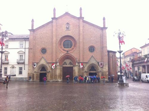 a group of people standing in front of a church at Appartamento in centro storico in Asti