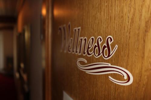 a wooden wall with the word wellness written on it at Hotel Flatscher in Stuhlfelden