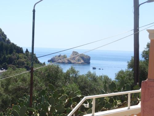 a view of the ocean from the balcony of a house at Korina Studios in Paleokastritsa