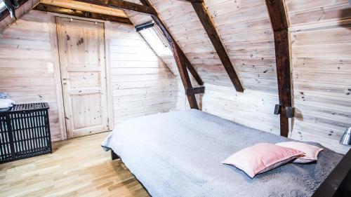 a bedroom with a bed in a wooden cabin at Bergen central city apartments in Bergen