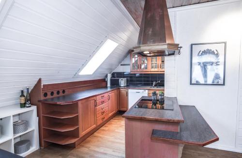 a kitchen with a large island in a attic at Bergen central city apartments in Bergen